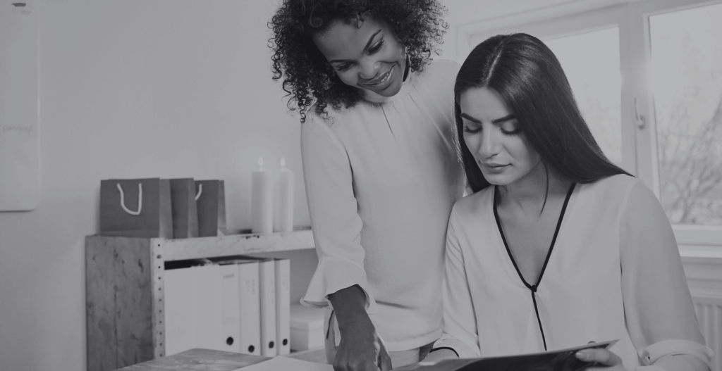 Two women looking at document